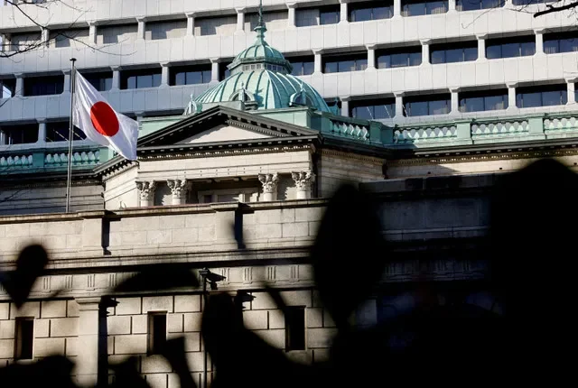 A Japanese flag flies above the Bank of Japan's main office in Tokyo, captured on December 19, 2025. REUTERS/Manami Yamada/File Photo