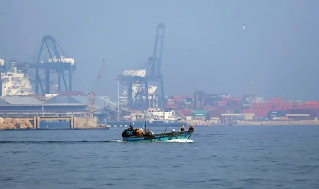 A fishing vessel navigates the Mediterranean waters near an industrial oil facility in Alexandria, Egypt, captured in July 2017. REUTERS/Mohamed Abd El Ghany