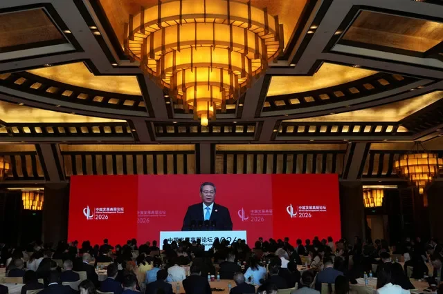 A big screen shows Premier Li Qiang speaking at the opening of the China Development Forum 2026 at the Diaoyutai State Guesthouse. Ng Han Guan/Pool via REUTERS