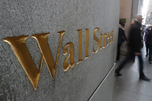 A street sign for Wall Street is pictured outside the New York Stock Exchange in New York City. REUTERS/Shannon Stapleton