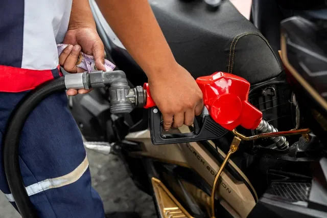 A gas station attendant refuels a motorcycle in Quezon City, Metro Manila, as the nation anticipates rising fuel costs due to the escalating conflict in the Middle East, March 9, 2026. REUTERS/Lisa Marie David