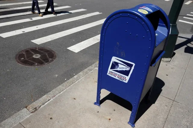 A blue United States Postal Service mailbox is pictured on a street in Manhattan, New York City. REUTERS/Andrew Kelly