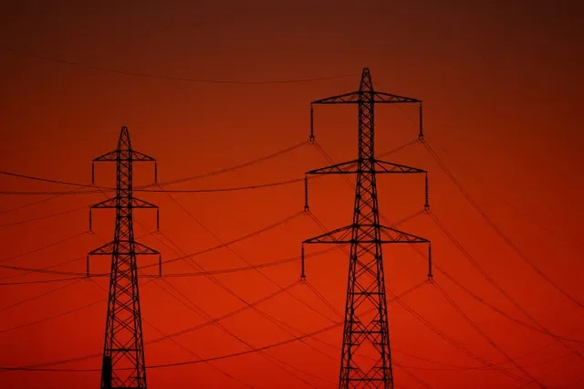 High tension power lines and pylons silhouetted against a sunset in Fos sur Mer, France, on March 12, 2026. REUTERS/Manon Cruz