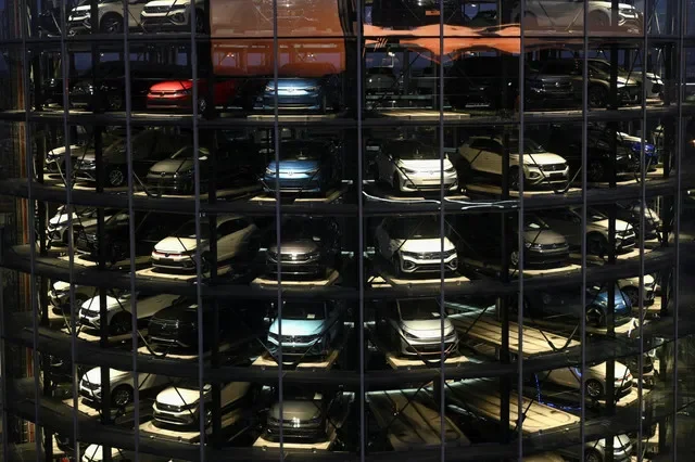 A view through glass of the car delivery towers at the Volkswagen manufacturing facility in Wolfsburg, Germany, captured in late 2025. REUTERS/Annegret Hilse