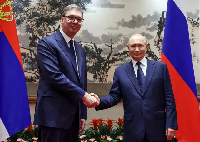 Russian President Vladimir Putin and Serbian President Aleksandar Vucic shake hands during a 2025 meeting in Beijing. Sputnik/Alexander Kazakov/Pool via REUTERS