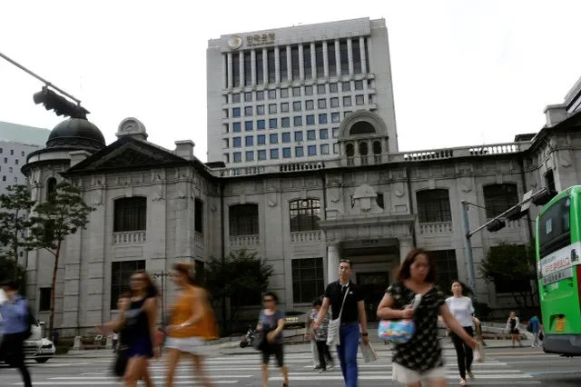 Pedestrians cross a street in front of the Bank of Korea building in Seoul, South Korea, in this 2016 file photo. REUTERS/Kim Hong-Ji/File Photo