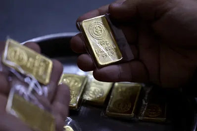 Gold reaches near two-week high as dollar and yields drop