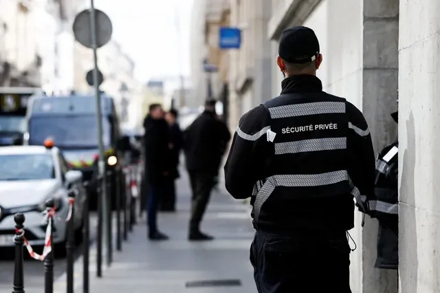 A private security member stands outside Bank of America’s Paris offices, after French anti-terrorism prosecutors opened an investigation into attempted destruction by fire or other dangerous means in Paris, France, March 30, 2026. REUTERS/Benoit Tessier
