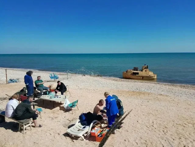 Rescued crew members from a dry cargo ship that reportedly sank in the Sea of Azov receive assistance on the coast of the Russian-controlled Kherson region, Ukraine, in an image released April 5, 2026. Vladimir Saldo via Telegram/Handout via REUTERS