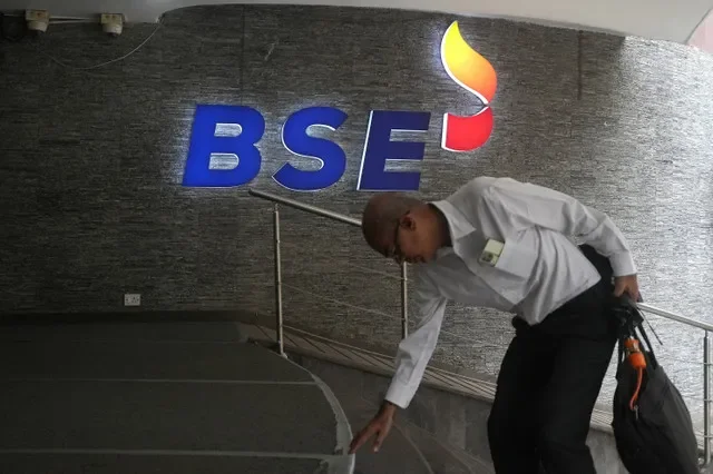 A man touches the stairs as he arrives at the Bombay Stock Exchange (BSE) building in Mumbai, India, August 1, 2025. REUTERS/Hemanshi Kamani