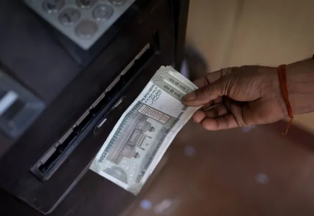 A person uses an ATM to withdraw cash in New Delhi, India, during April 2025. REUTERS/Adnan Abidi