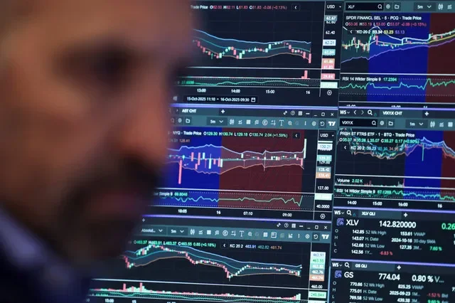 A financial professional monitors market activity on the New York Stock Exchange floor in New York City, October 2025. REUTERS/Jeenah Moon/File Photo
