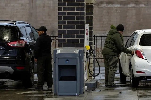 Motorists are seen fueling their cars at a Chicago gas station amid rising energy costs in early April. REUTERS/Jim Vondruska