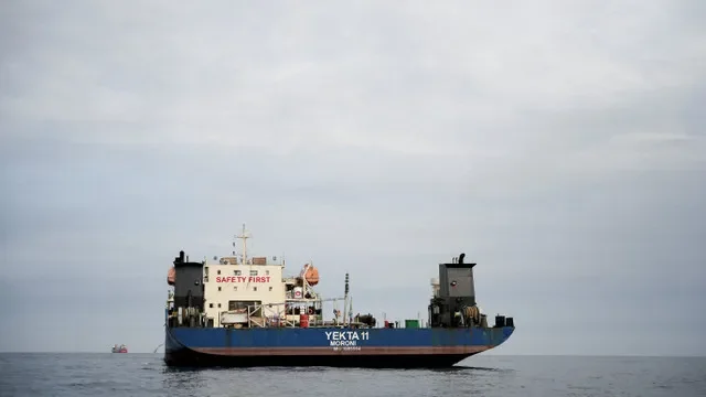 A ship passes through the Strait of Hormuz in the Musandam province of Oman, April 12, 2026. REUTERS