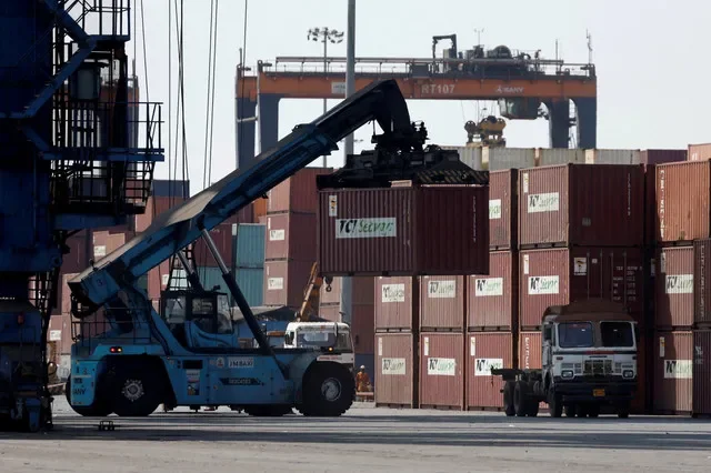 A mobile crane moves a shipping container at Deendayal Port in Gujarat, India, during operations in April 2025. REUTERS/Amit Dave/File Photo