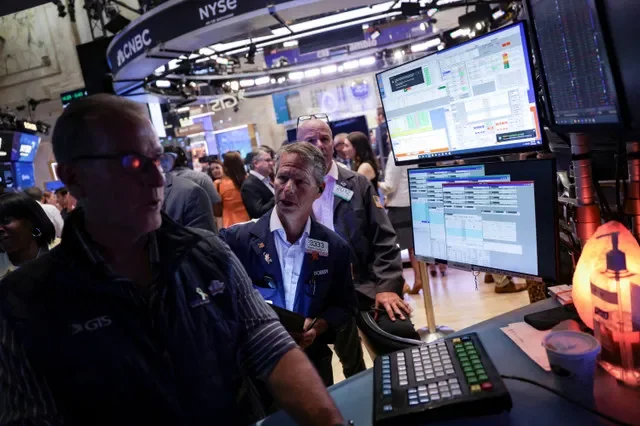 Financial professionals are seen operating on the New York Stock Exchange floor during a trading session in July 2025. REUTERS/Jeenah Moon/File Photo