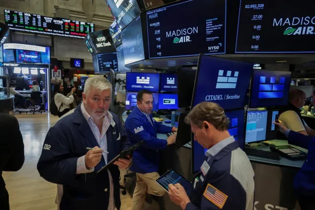 Traders work on the floor of the New York Stock Exchange in New York City during a period of increased market activity, April 16, 2026. REUTERS/Jeenah Moon