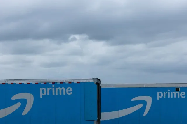 Two Amazon Prime delivery trucks parked at a rest area near Oceanside, California, in late March 2026. REUTERS/Mike Blake