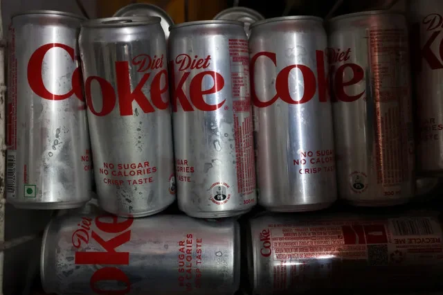 A collection of Diet Coke cans chilled in a shop refrigerator in New Delhi, India, captured on April 22, 2026. REUTERS/Bhawika Chhabra