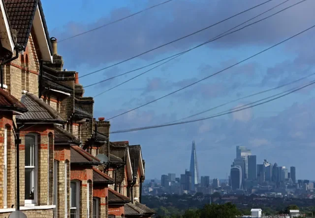 A view of the City of London skyline contrasted with Victorian-style residential homes in South London, captured on August 1, 2023. REUTERS/ Susannah Ireland