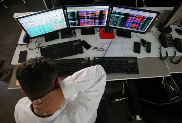 A trader monitors market movements at a brokerage office in Mumbai, India. REUTERS/Francis Mascarenhas