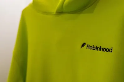 Robinhood is introducing digital assistants that can autonomously trade stocks and use virtual credit cards for automated purchases. The company implemented guardrails such as spending limits and manual approvals to address security concerns as it plans future expansions into crypto and derivatives.
