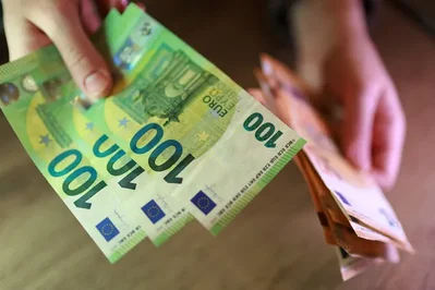 The euro eased after an ECB rate hike while the dollar held near a two-month high on Iran tensions. U.S. producer prices rose more than expected during May.