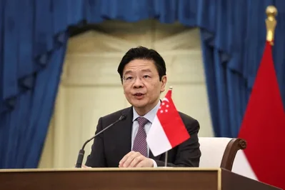 Prime Minister Lawrence Wong announced a cabinet reshuffle on Wednesday that places Tan See Leng and Gan Kim Yong in charge of the trade ministry. The move focuses on energy and industrial transformation while promoting several junior ministers to full cabinet roles following recent leadership changes.