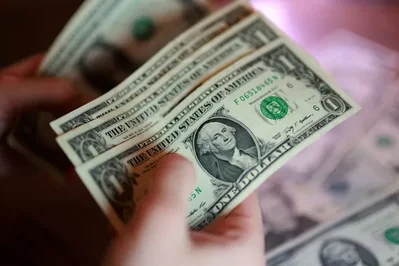 The U.S. dollar remained at a one-month high on Tuesday as traders assessed a nearly 38% chance of a Federal Reserve rate hike this week. While falling oil prices eased some inflation concerns, the greenback stayed supported against the yen and euro ahead of key central bank meetings and GDP data.