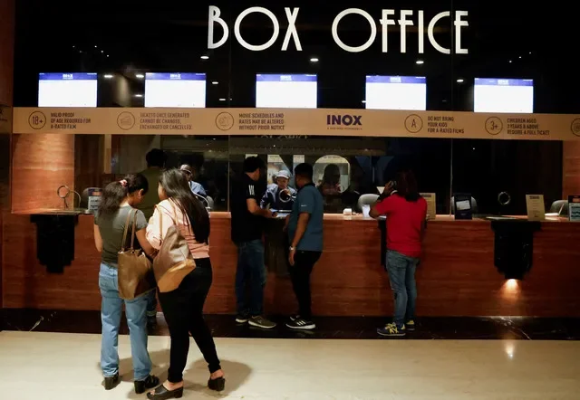 FILE PHOTO: People wait in queue to purchase movie tickets at an INOX multiplex cinema hall inside a shopping mall in Kolkata, India, February 22, 2024. REUTERS/Sahiba Chawdhary/File Photo