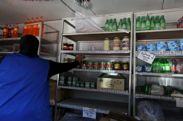 FILE PHOTO: A worker sells subsidized food commodities at a government-run supermarket in Cairo, Egypt, February 14, 2016. REUTERS/Mohamed Abd El Ghany/ File Photo