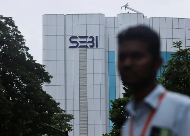 A man stands in front of logo of the Securities and Exchange Board of India (SEBI) headquarters in Mumbai, India, September 6, 2024. REUTERS/Francis Mascarenhas