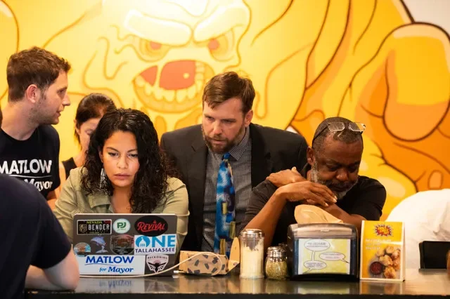 Ryan Ray, aide to Jeremy Matlow and chair of the Leon County Democratic Party, huddles with former Matlow campaign manager Kristellys Estanga at Gaines Street Pies, 104 E. 6th Avenue, in Tallahassee on election night, Aug. 18, 2026. Estanga resigned her role after she accepted responsibility for posting body camera video of Talethia Edwards under a fake conservative Facebook page. Estanga is