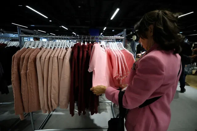 FILE PHOTO: A customer looks at clothes in the first physical space of Chinese online fast-fashion retailer Shein on the day of its opening inside the Le BHV Marais department store, the Bazar de l'Hotel de Ville, in Paris, France, November 5, 2025. REUTERS/Sarah Meyssonnier/File Photo
