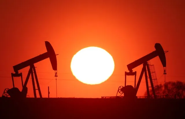 The sun sets behind oil pumps outside Vaudoy-en-Brie, near Paris, France, March 18, 2026. REUTERS/Christian Hartmann