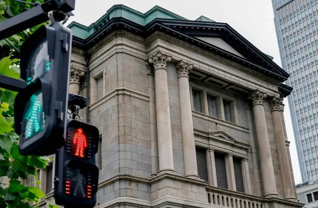 FILE PHOTO: Traffic signs in front of the Bank of Japan building in Tokyo, Japan, June 15, 2026.