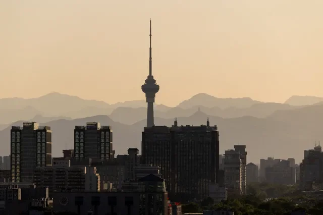 China Central Radio and Television Tower rises against city skyline and distant mountain ridges during sunset time in Beijing, China, May 7, 2026. REUTERS/Maxim Shemetov