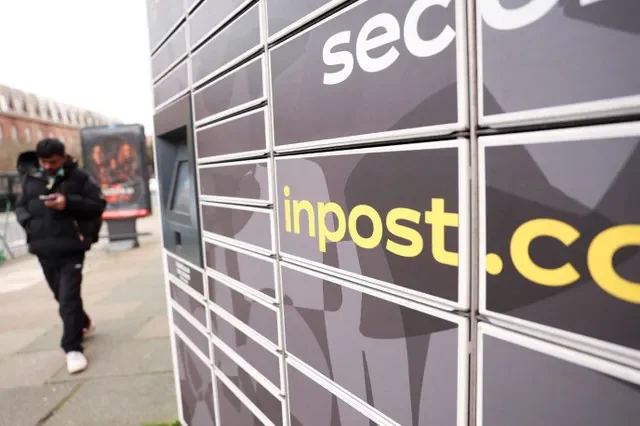 FILE PHOTO: A man walks past an InPost locker in London, Britain, February 18, 2026.
