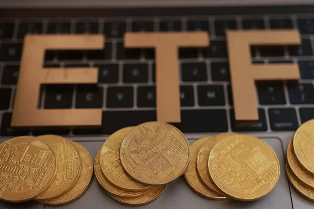 تظهر كلمة "ETF (Exchange-Traded Fund)" مطبوعة بتقنية ثلاثية الأبعاد ونماذج للعملات المشفرة موضوعة على لوحة مفاتيح في هذا الرسم التوضيحي الملتقط في 16 أكتوبر 2025. REUTERS/Dado Ruvic/Illustration
