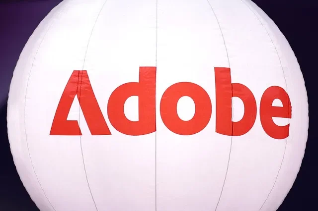 A logo of computer software company Adobe is seen during the Adopt AI International Summit at the Grand Palais in Paris, France, November 26, 2025. REUTERS/Abdul Saboor