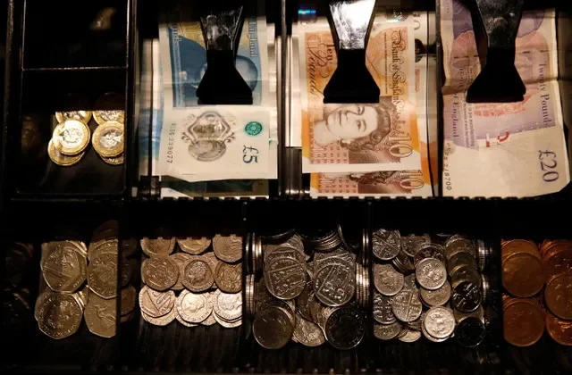 FILE PHOTO: Pound Sterling notes and change are seen inside a cash resgister in a coffee shop in Manchester, Britain, Septem,ber 21, 2018. REUTERS/Phil Noble/ File Photo