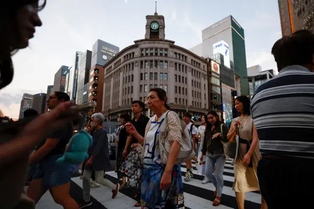 People cross the street at Ginza shopping district in Tokyo, Japan, August 11, 2024. REUTERS/Willy Kurniawan