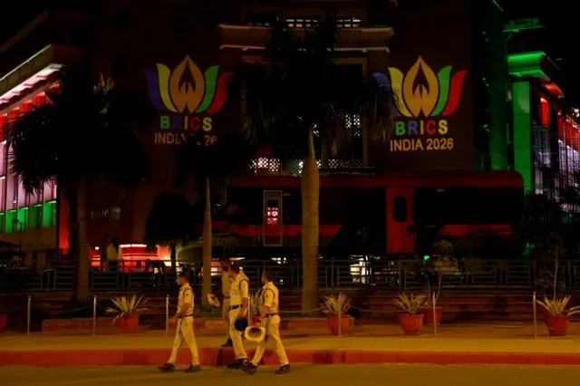 Security personnel walk past a projection of the BRICS logo on the Railway Bhawan building ahead of the upcoming BRICS Summit in New Delhi, India, September 8, 2026. REUTERS/Bhawika Chhabra