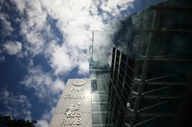 The logos of companies Rand Merchant Bank, FNB, and Wesbank are seen outside the FirstRand offices in Cape Town, South Africa, March 11, 2019. REUTERS/Mike Hutchings