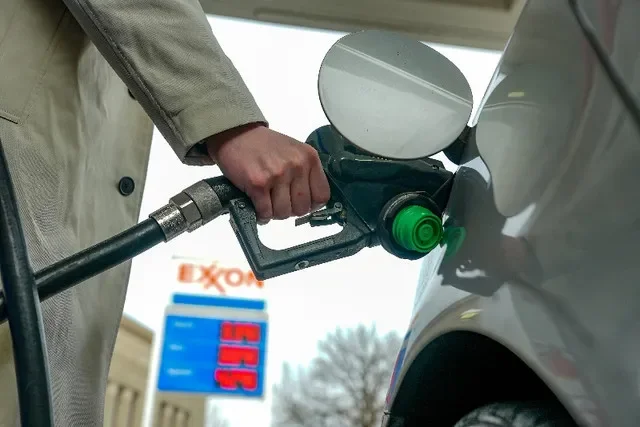 FILE PHOTO: A man pumps gas at an Exxon station in Washington, D.C., U.S., March 5, 2026. REUTERS/Ken Cedeno/File Photo