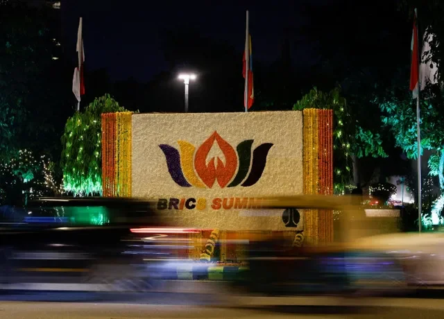 Traffic passes in front of a floral arrangement with the BRICS Summit logo, ahead of the 18th BRICS Summit in New Delhi, India, September 11, 2026.