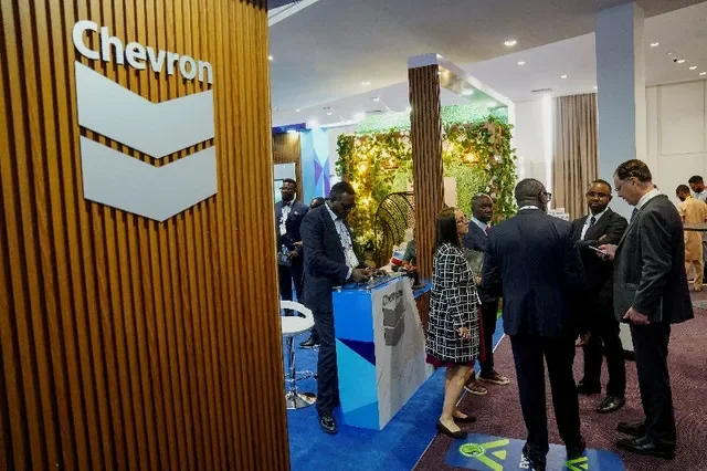 Visitors discuss in front of the Chevron booth during the Nigeria International Energy Summit at the Bola Ahmed Tinubu International Conference Centre in Abuja, Nigeria, February 4, 2026. REUTERS/Marvellous Durowaiye
