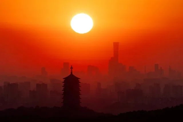 Yongding Pagoda stands against the rising sun and Beijing skyline, with skyscrapers in the Central Business District, including the CITIC Tower and CCTV headquarters, seen in the seen in the distance, in Beijing, China, September 3, 2026. REUTERS/Maxim Shemetov