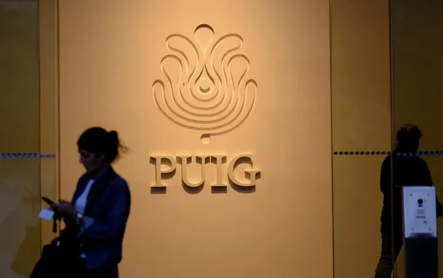People walk past the logo of luxury beauty and fashion company Puig (PUIG.MC) at the entrance of its headquarters in Barcelona, Spain October 9, 2024. REUTERS/Nacho Doce