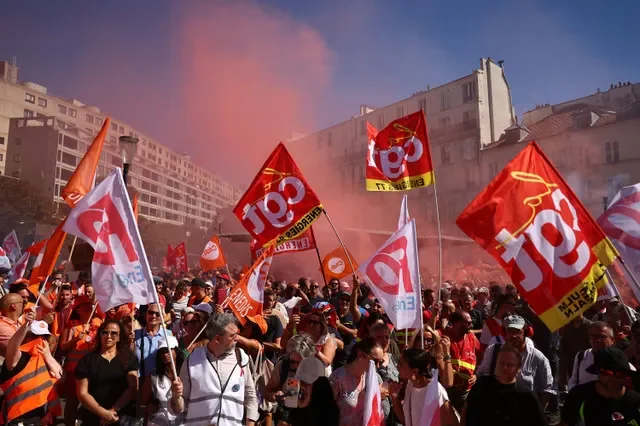 Workers from the energy sector hold CGT labour union flags and red smoke flare during a demonstration against plans to end their discounted electricity rate, a benefit that forms part of their remuneration, outside the French Economy and Finance Ministry, known as Bercy, in Paris, France, September 15, 2026. REUTERS/Abdul Saboor